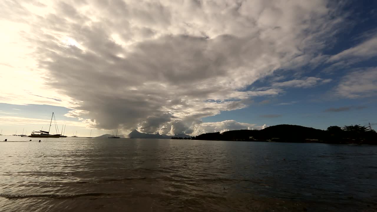 View on tahitian sea from frog perspective. Water calmly hits the shore