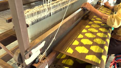 artisan weaving intricate silk patterns by hand