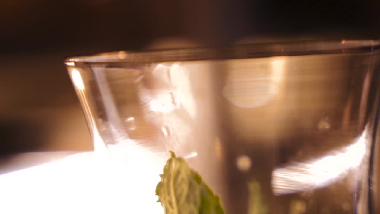 adding brown sugar to drink glass in slow motion