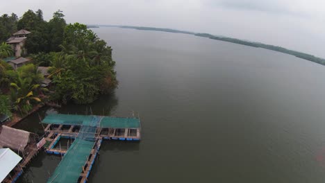 FPV-Overtake-Shot-Of-Blue-Cabins-Floating-On-Calm-Clear-Sea,-Sri-Lanka