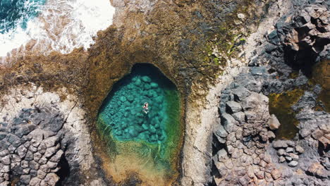 Aerial-of-a-secluded-cove-with-turquoise-waters-in-Caleta-de-Fuste