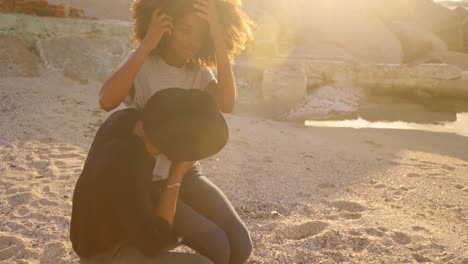 couple sitting together on the beach 4k