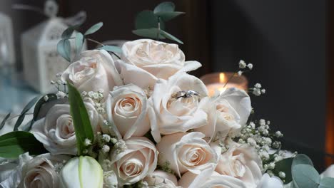 Anillos-De-Boda-De-Oro-Blanco-Entre-Los-Pétalos-De-Rosas-Blancas-Del-Ramo-De-La-Novia.