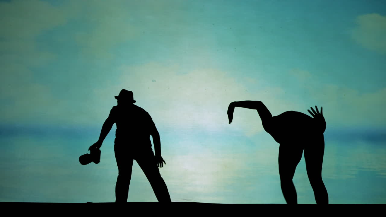 Silhouettes of people performing on stage