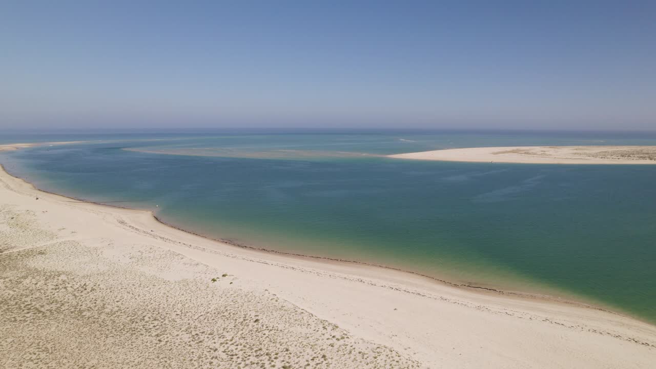 tranquila playa de arena serena con extensas dunas y aguas tranquilas protegidas