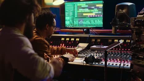 guitarist recording his electro acoustic instrument and song in studio