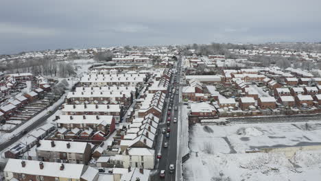 Aerial-view-heavy-traffic-on-Anchor-road-Longton,-a-sudden-snow-blizzard-in-Stoke-on-Trent,-dangerous-driving-conditions,-cars-travelling-slowly,-safely,-West-Midlands