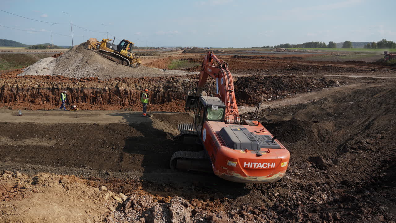 Heavy Machinery and Workers on a Construction Site