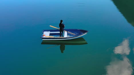 Woman-on-the-boat-catches-a-fish-on-spinning-in-Norway.