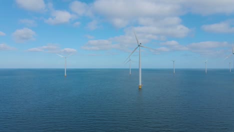 huge windmill turbines, offshore windmill farm in the ocean westermeerwind park , windmills isolated at sea on a beautiful bright day netherlands flevoland noordoostpolder