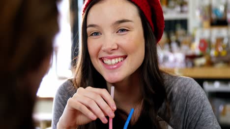 woman having a drink with a straw