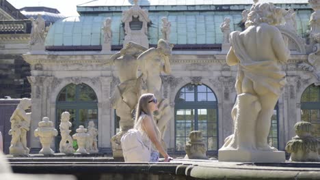 tourist exploring the magnificent zwinger palace gardens and statues in dresden