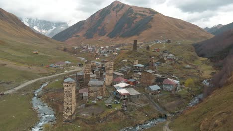 drone flying away from an old village in georgia hidden in the caucasus mountains