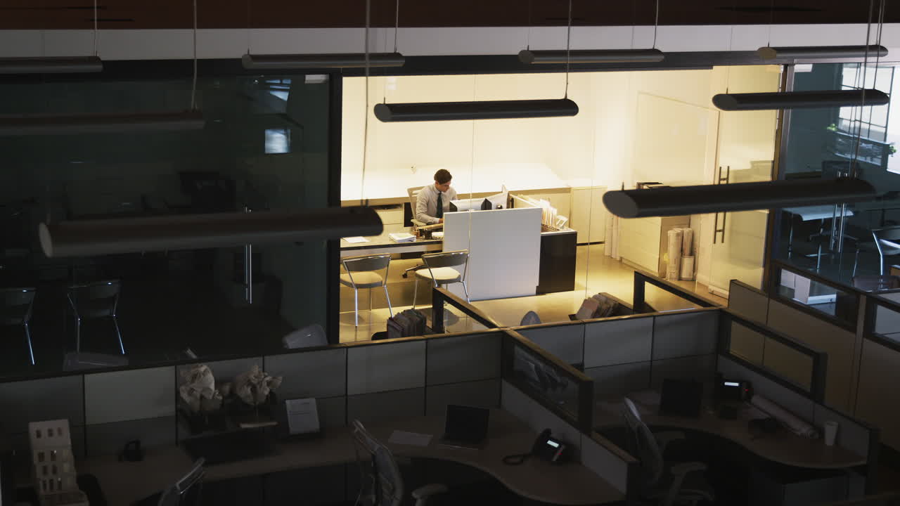 Young manager working alone in an empty office, elevated view