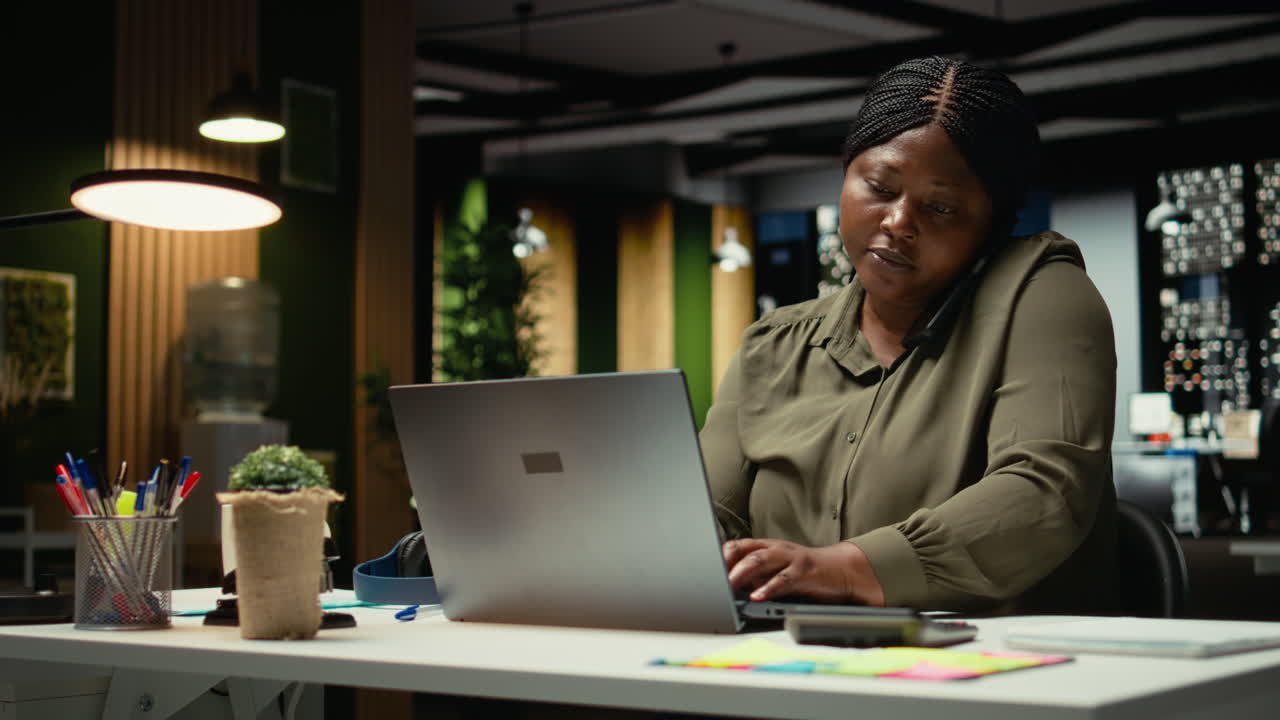 African american assistant taking a phone call for a remote chat with CEO