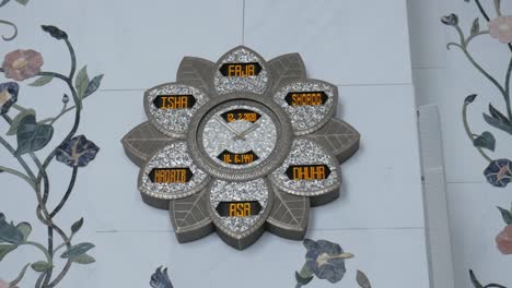 flower islamic prayer clock with prayer timings on masjid wall