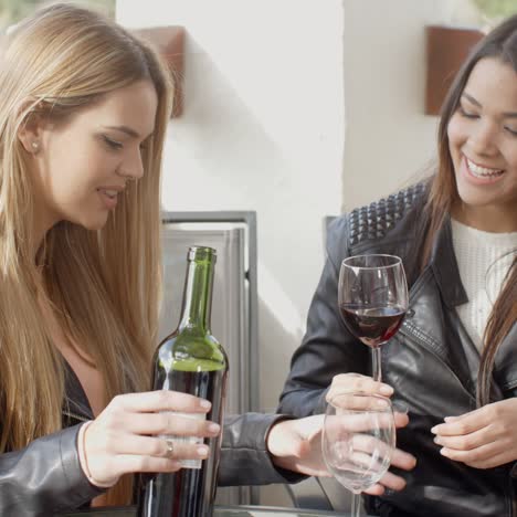 Friend-pouring-woman-wine-at-table