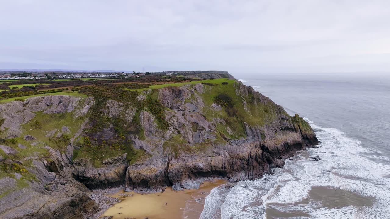 Ascending above the steep cliffs to reveal Pennard Village on the Gower Peninsula