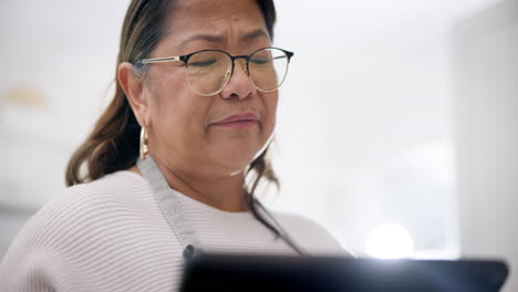 kitchen, thinking and senior woman with tablet