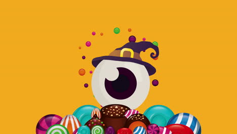 halloween eye with witch hat and sweet candies