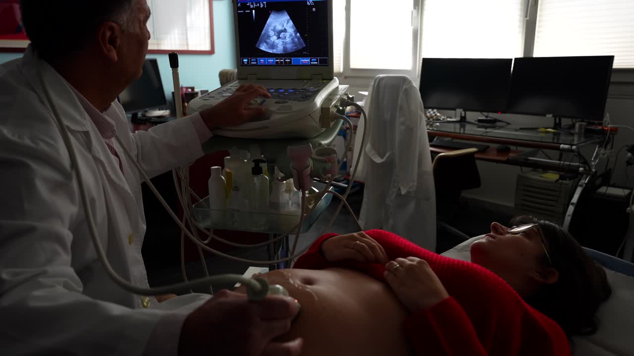 Happy relaxed woman during ultrasound as gynecologist confirms baby's health, 4K