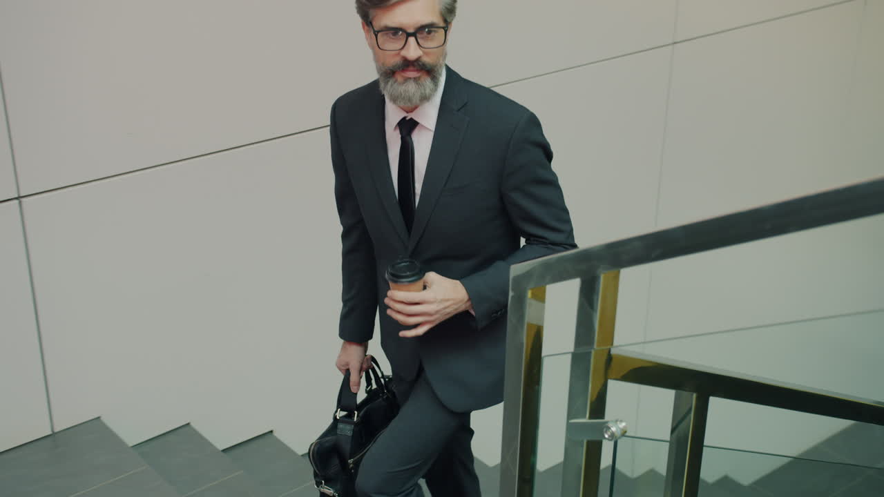 Businessman Walking Upstairs with Coffee