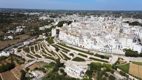 Aerial-view-over-Locorotondo-village-houses,-traditional-italian-hilltop-town,-on-a-sunny-day