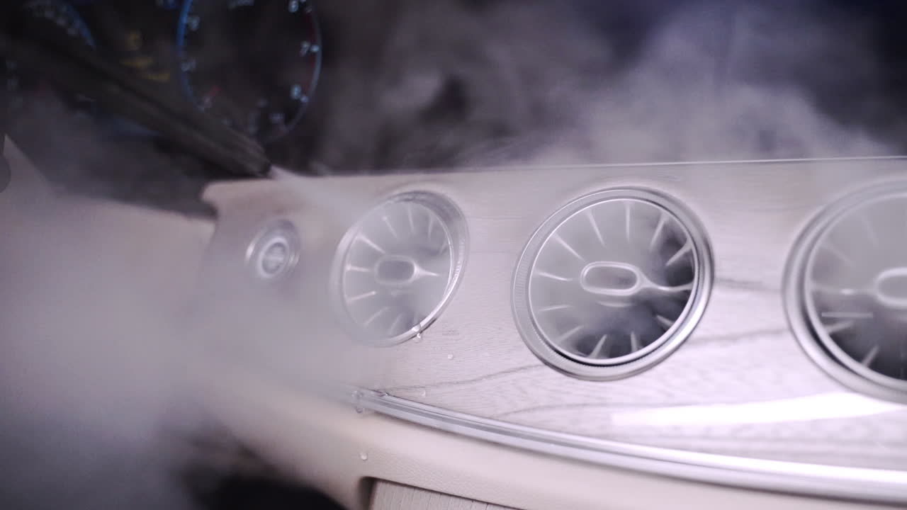 에어컨 통풍구에서 증기가 나오는 제어 및 환기 기능을 갖춘 미래 지향적인 현대 자동차 대시보드의 회전 샷