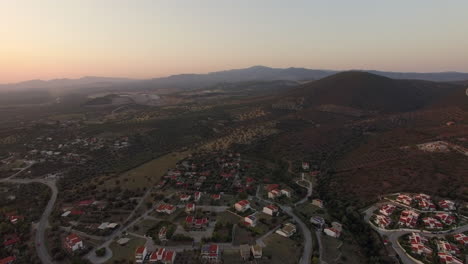 aerial scene of cottages green landscape with hills and plains in greece