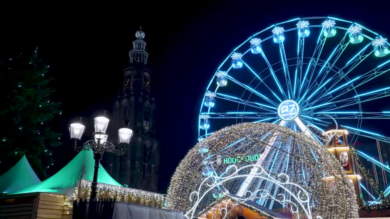Ferris wheel and city architecture at night