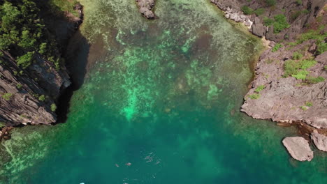 Aerial-Reveal-Top-Shot-Of-A-Beautiful-Clear-Cove-While-Sunny-Day-In-El-Nido-Palawan-Philippines