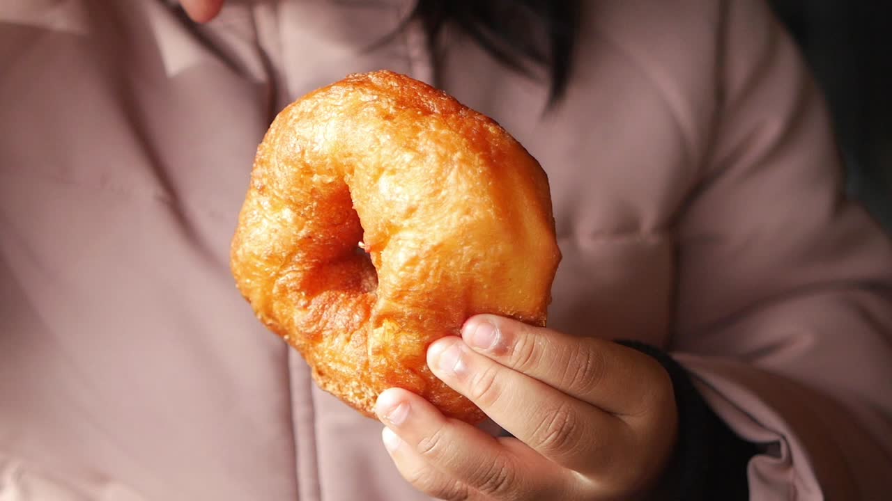 A delicious doughnut being held