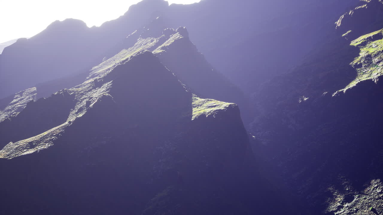 Majestic mountain peaks illuminated by sunlight in a serene landscape