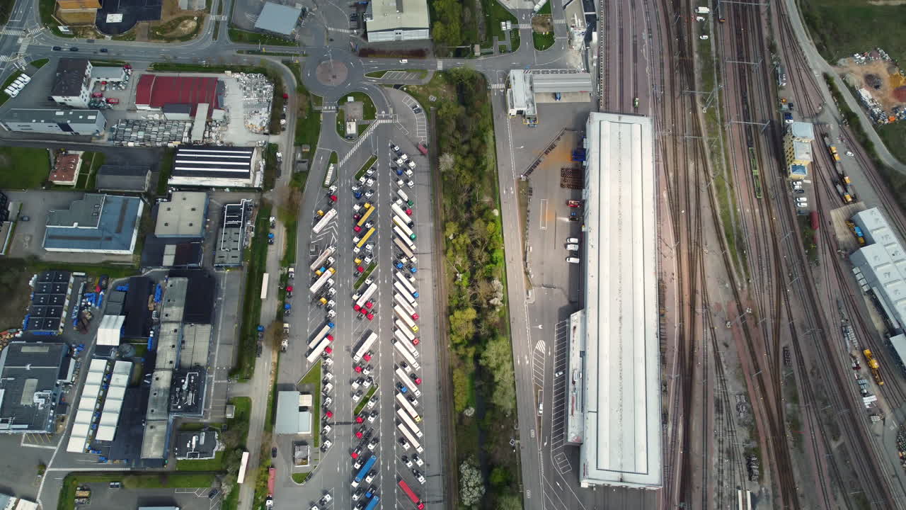 Aerial View of Industrial Complex with Trucks and Railroad