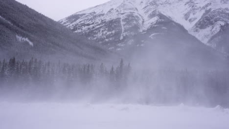 panning shot of a snow storm in the mountains.