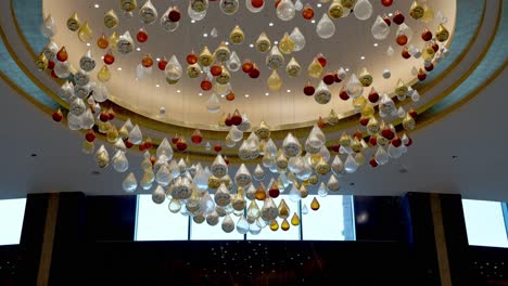 A-ceiling-decorated-by-colorful-glass-and-warm-LED-strip-in-a-large-hotel-in-El-Alamein,-Egypt-low-angle-shot,-push-in-shot