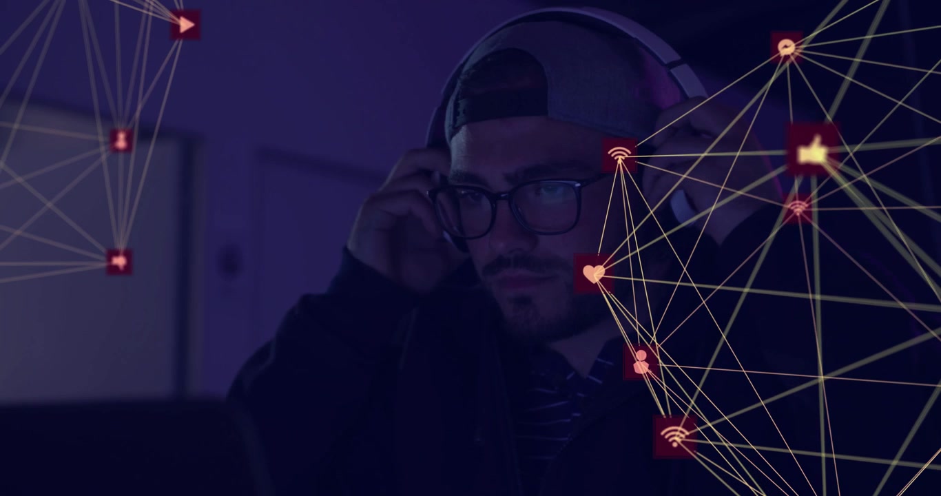 Man grabbing headphones after pulsing media icons while focusing laptop enhancing collaboration