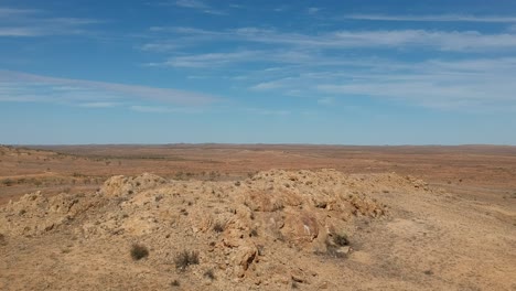 a huge rocky outcrop in the desolate outback of australia