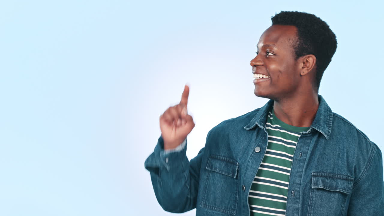Smile, pointing and black man in studio