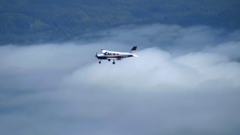 a small airplane flying above the clouds, air to air view