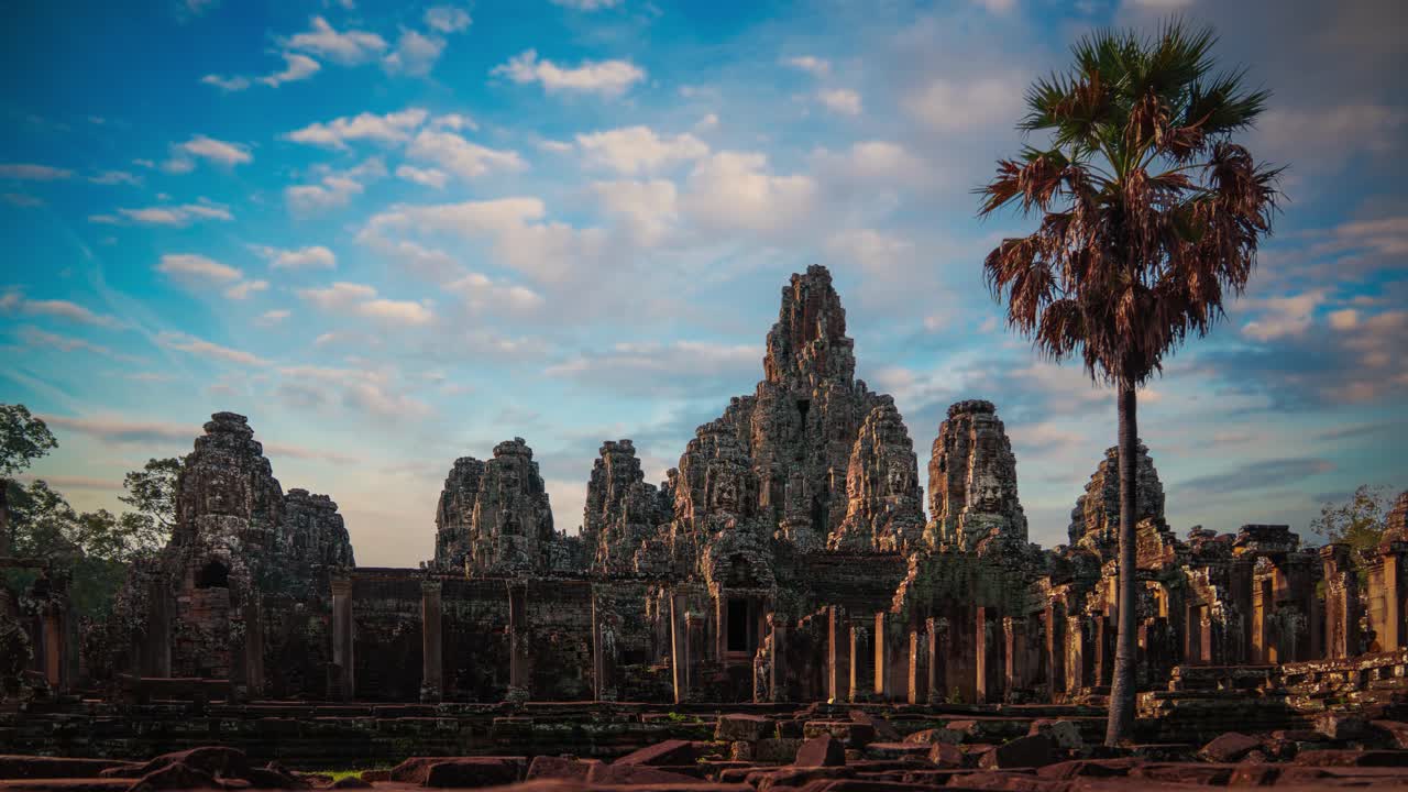 Bayon Temple smiling stone faces at Angkor Wat, Cambodia. Time lapse of Clouds moving across the sky