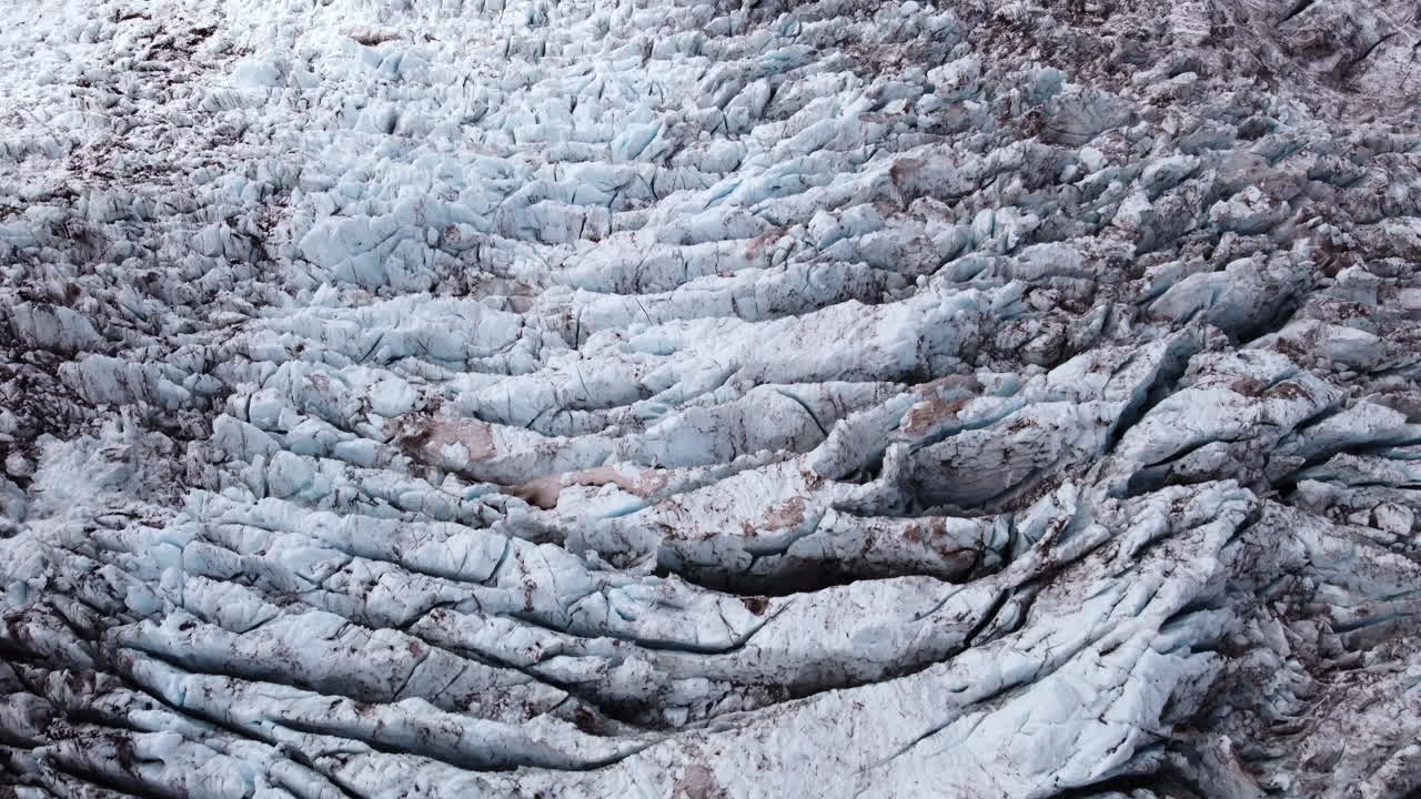 Glaciers have crevasse fields where ice brakes under pressure and creates beautiful patterns together with volcanic ash