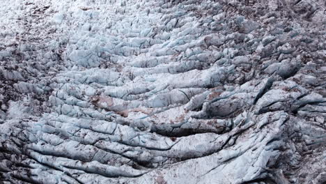 glaciers have crevasse fields where ice brakes under pressure and creates beautiful patterns together with volcanic ash