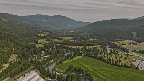 sicamous bc canada aerial v3 drone flyover eagle river capturing agricultural farmlands, golf country club, lush forests and mountainous landscape - shot with mavic 3 pro cine - july 2023