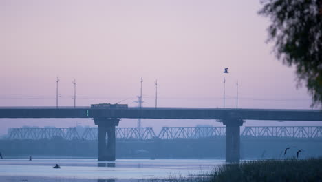 river city bridge tranquil dim morning. calm autumn evening coastline.