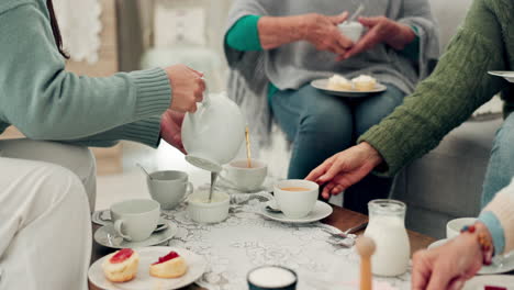 Hands,-tea-party-and-senior-friends-in-the-living