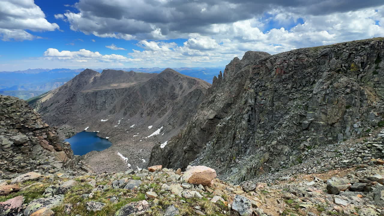 Tear of Bowls high alpine lake Halo Ridge Notch Mountain trail view Mount Holy Cross Wilderness Ridge saddle Peak 14er Colorado Sawatch Rocky Mountains sunny morning landscape blue sky clouds pan left