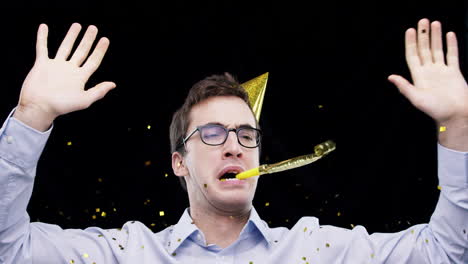 man celebrating with party hat and confetti