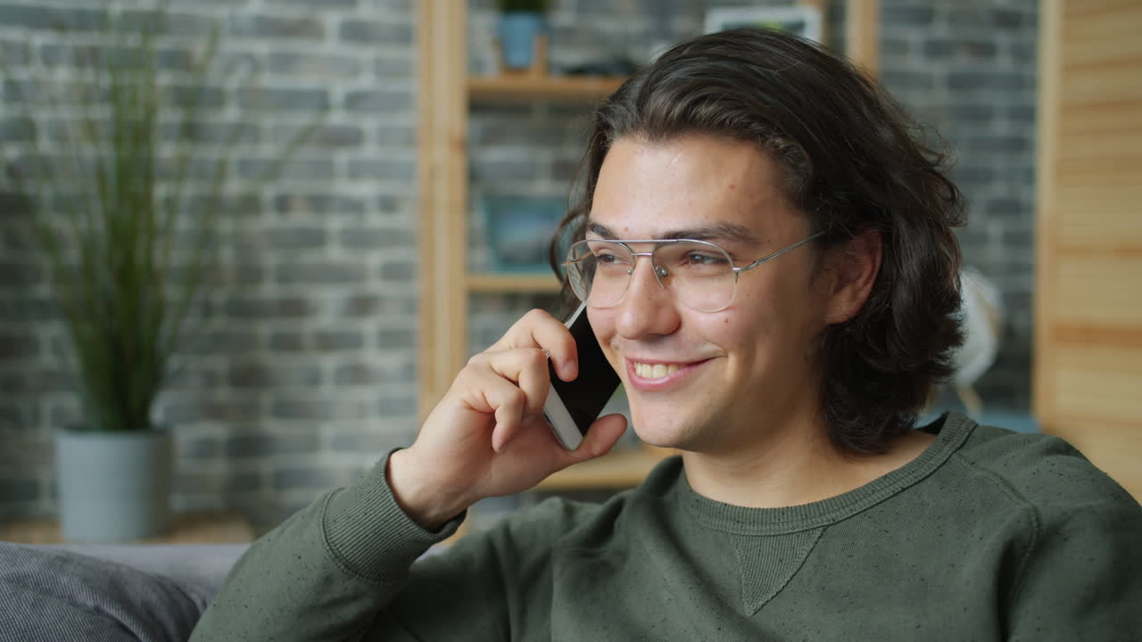 Young Man Talking on Phone at Home