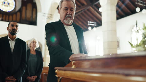 funeral, iglesia y hombre con la mano en el ataúd